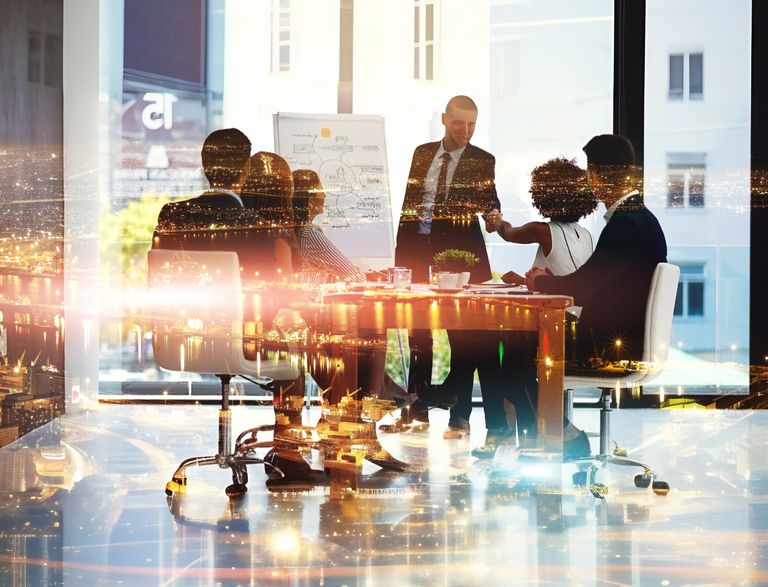 A blurred image of business people in a meeting, suggesting energy and speed.
