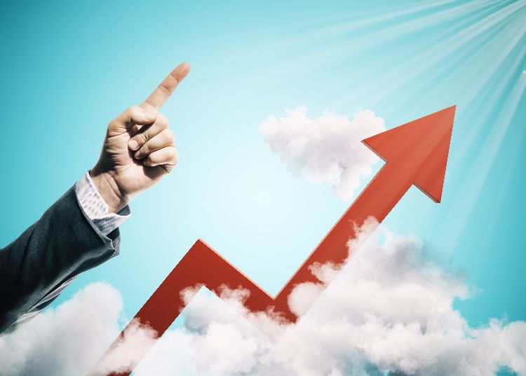 Hand holding an illuminated lightbulb with a brain, symbolizing Generating Momentum Through Innovation.